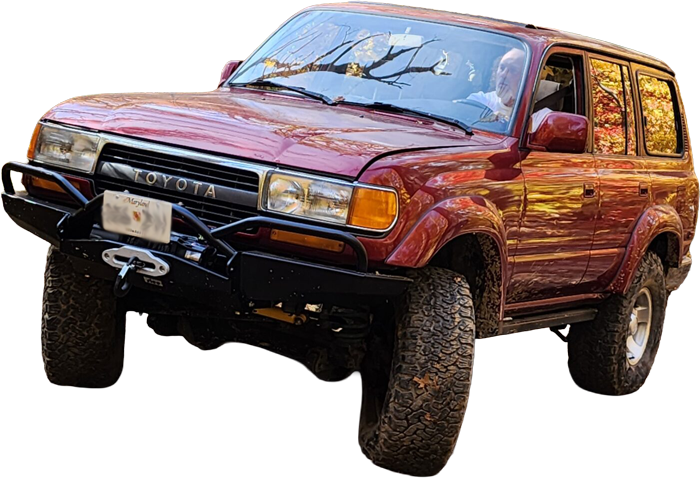 A land cruiser crawling over rocks.